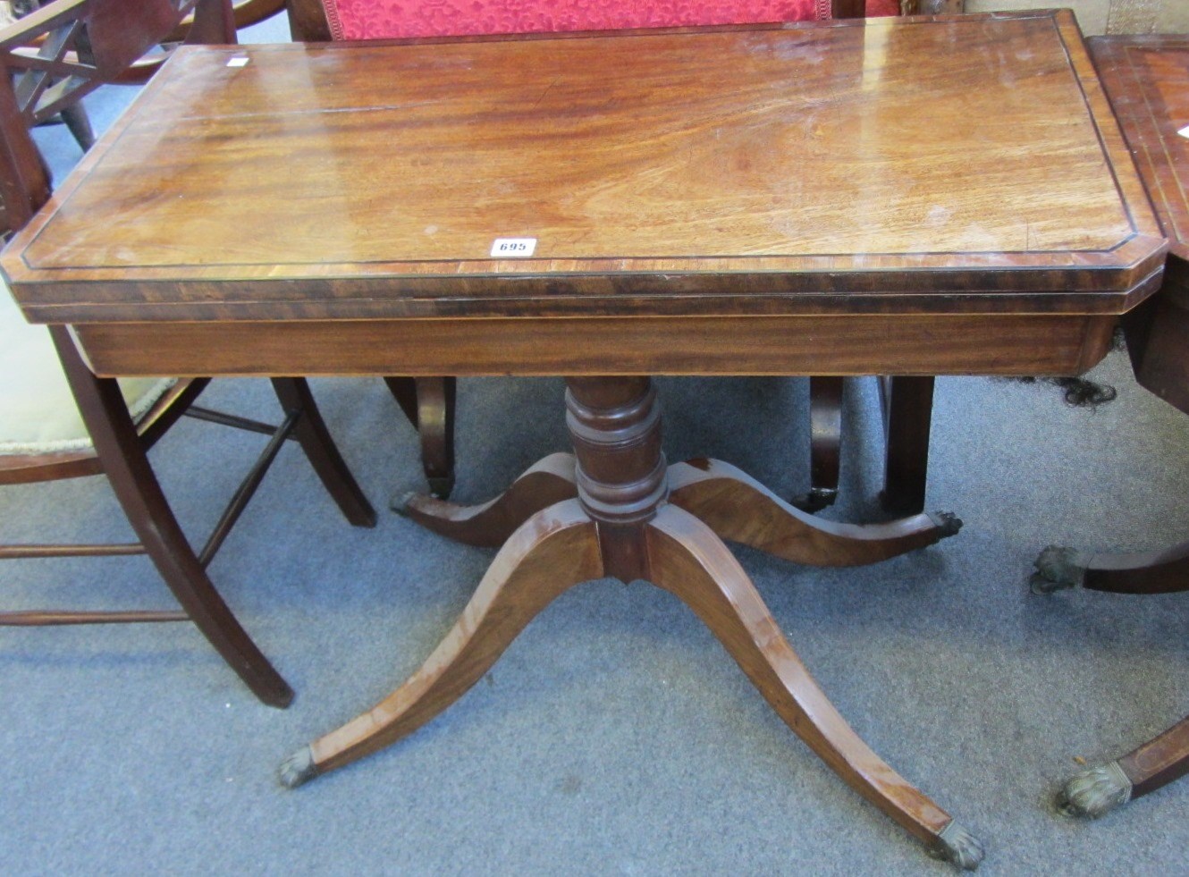 Appraisal: A George III mahogany card table the crossbanded rectangular top