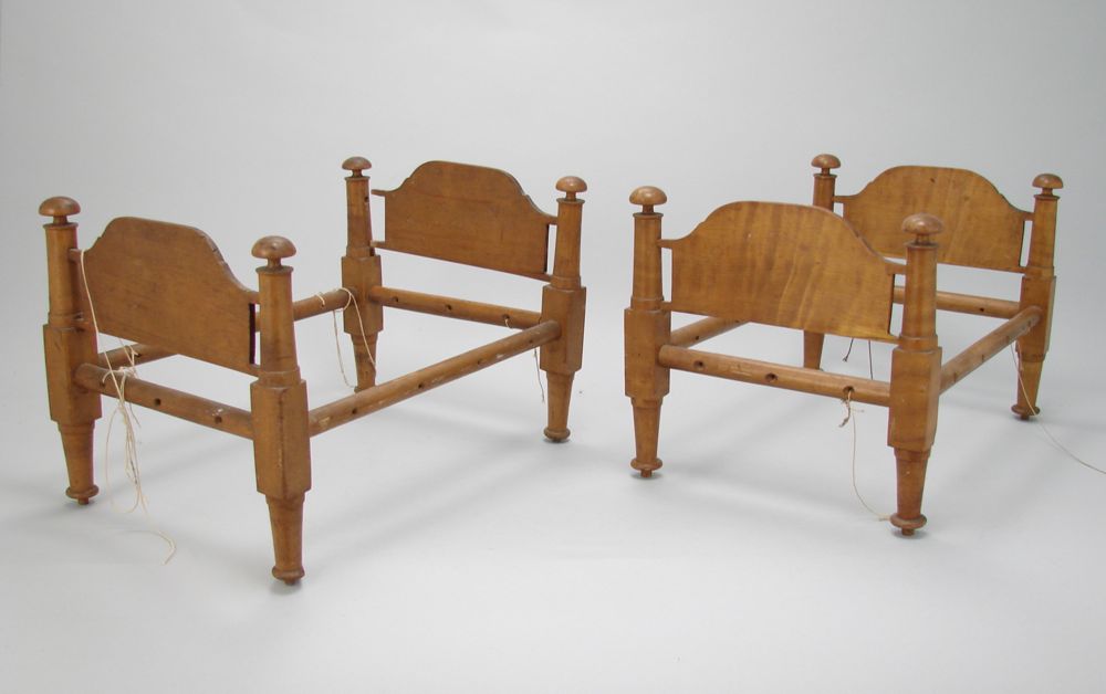 Appraisal: TWO ANTIQUE DOLL-SIZE ROPE BEDS One in tiger maple the