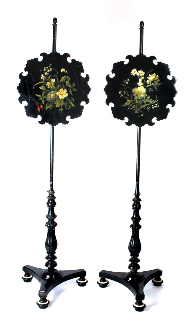 Appraisal: A pair of early th century ebonised pole screens with