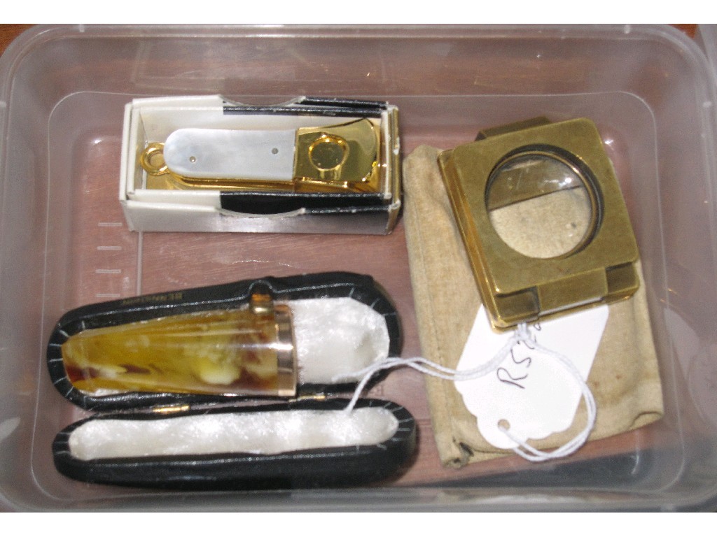 Appraisal: Lot comprising amber cigar holder cigar cutter and a magnifying