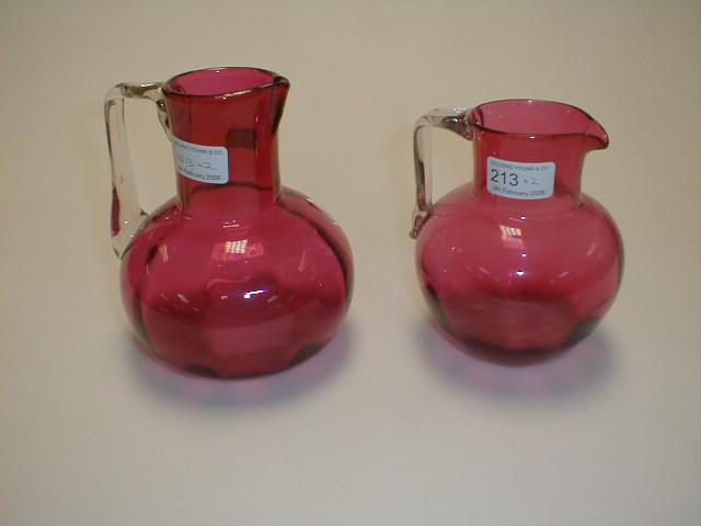 Appraisal: A cranberry glass jug of compressed circular shape with a