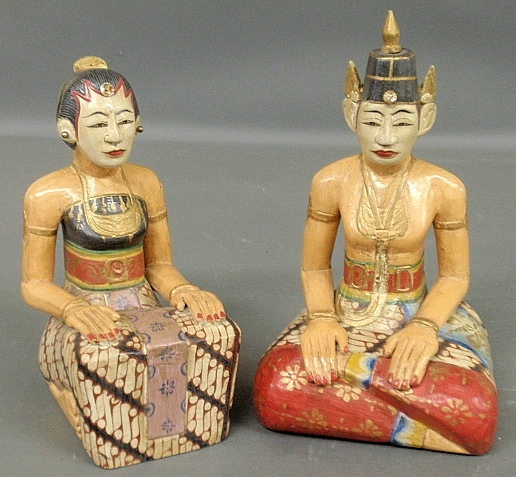 Appraisal: - Indonesian carved and polychrome decorated figures of a seated