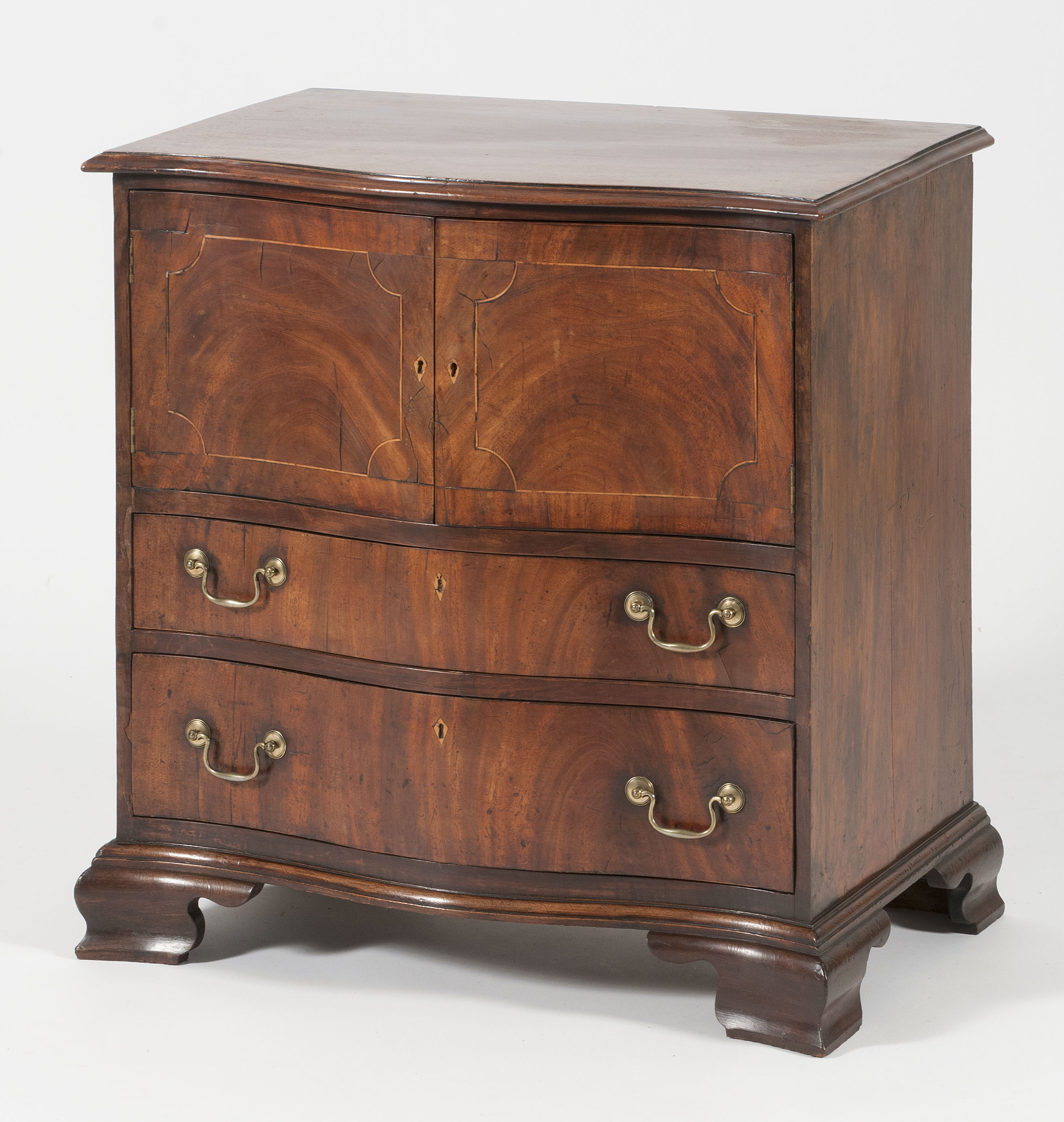 Appraisal: GEORGIAN-STYLE SERPENTINE-FRONT COMMODE Early th CenturyIn mahogany Two paneled cupboard