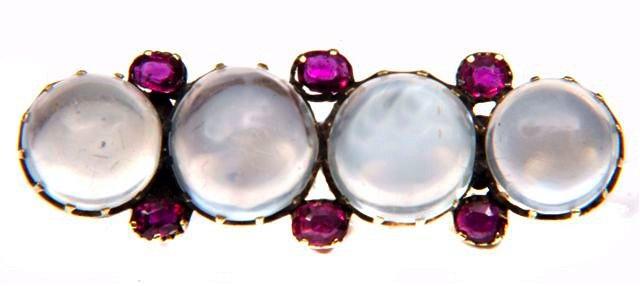 Appraisal: A MOONSTONE AND RUBY BROOCH four moonstones mounted in cut