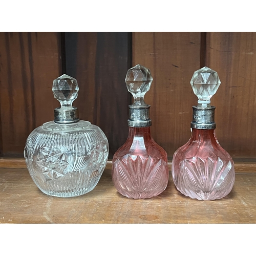 Appraisal: Pair of perfume bottles and another all with silver collars