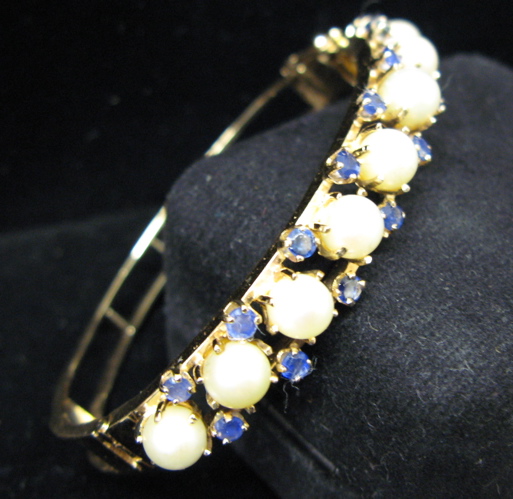 Appraisal: PEARL SAPPHIRE AND FOURTEEN KARAT GOLD BANGLE with nine round