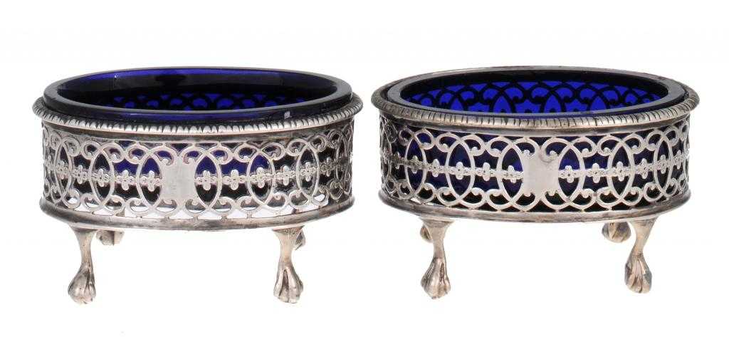 Appraisal: A PAIR OF VICTORIAN PIERCED OVAL SALTS with gadrooned rim