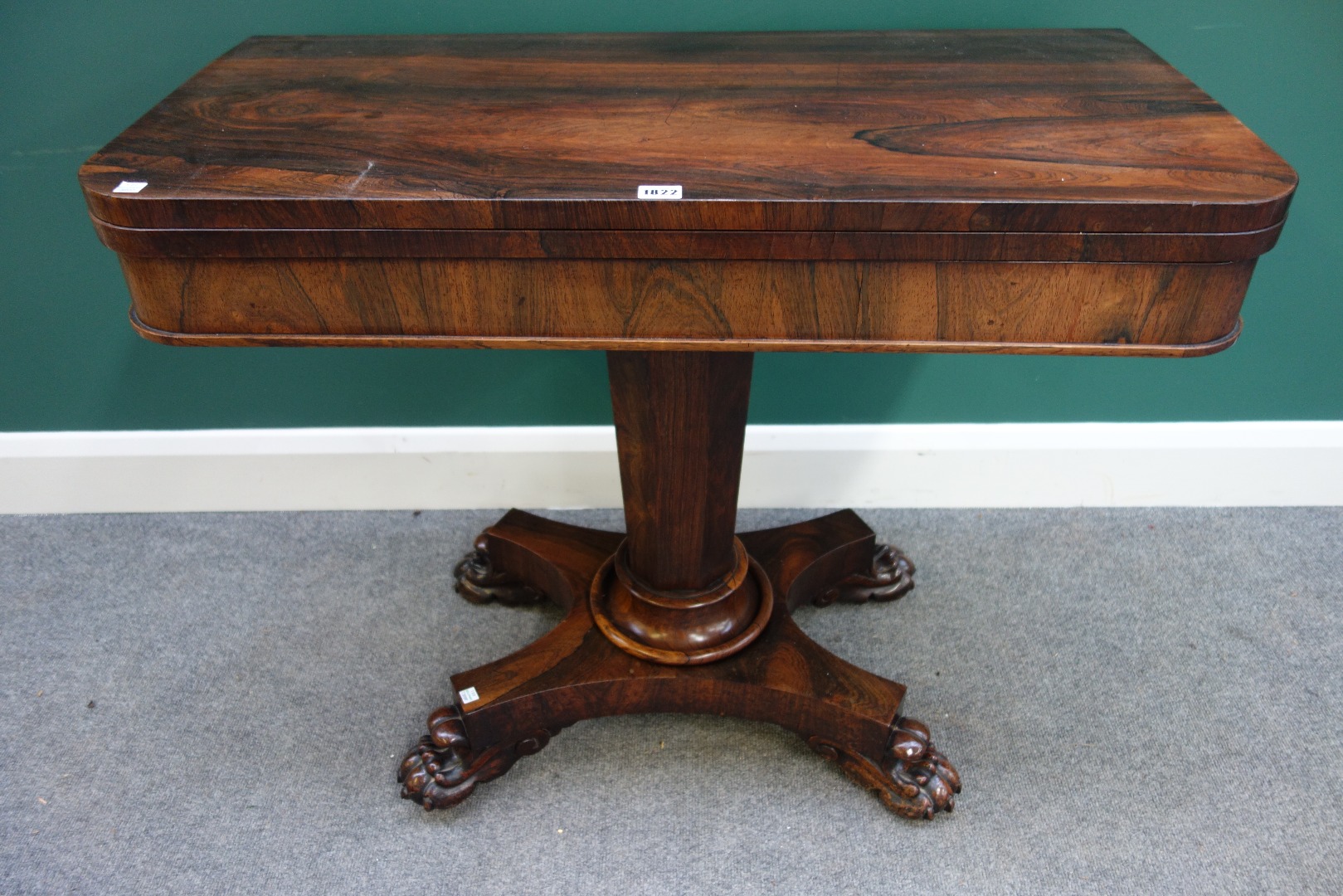 Appraisal: An early Victorian rosewood games table on tapering octagonal column