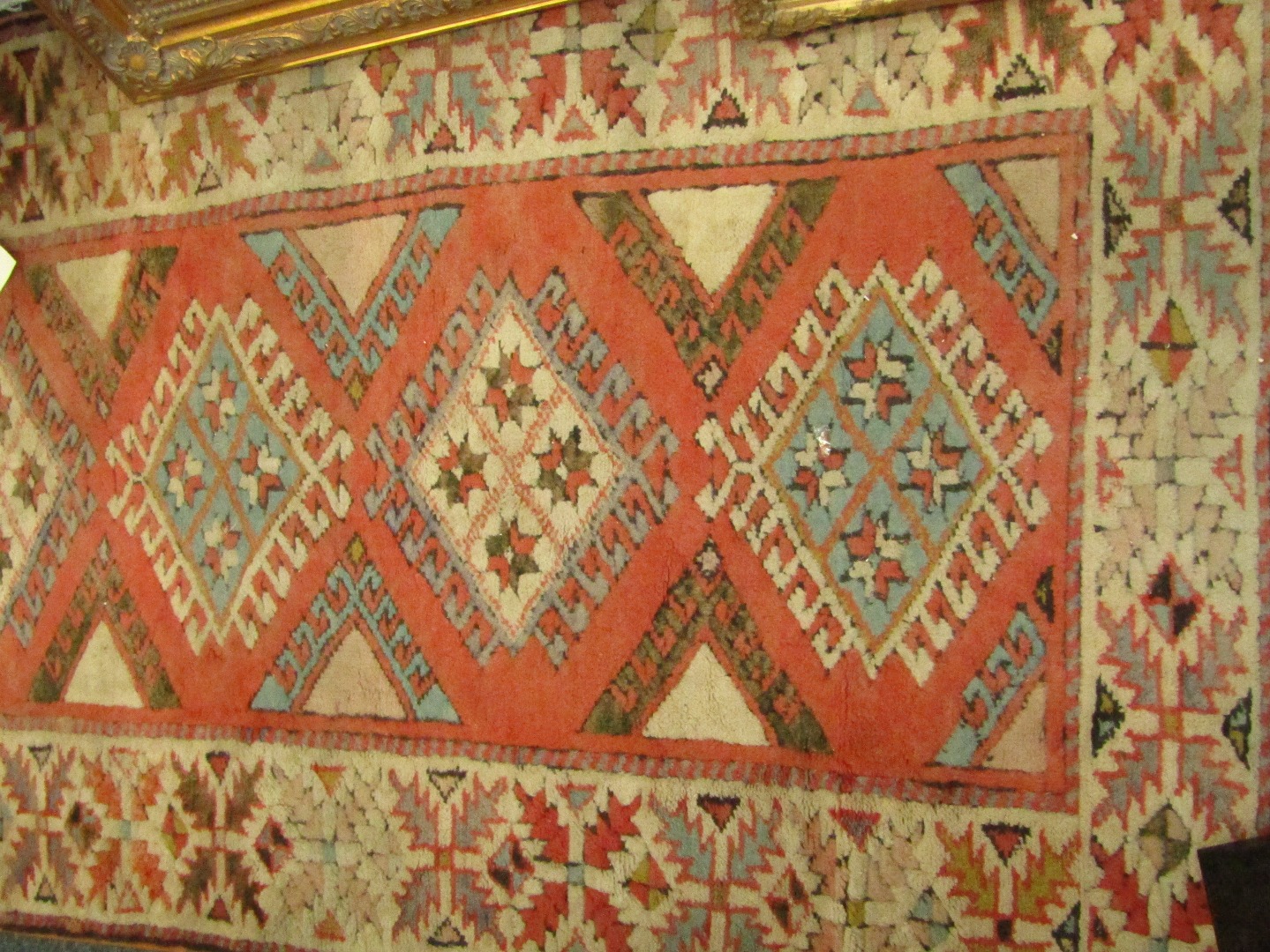 Appraisal: A Caucasian rug decorated with geometric motifs against a red