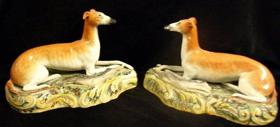 Appraisal: A pair of Staffordshire pottery figures of recumbent greyhounds each