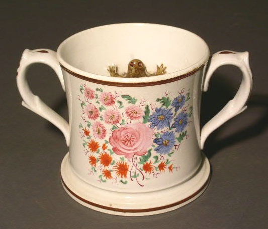 Appraisal: Porcelain double-handled mug with frog decoration h x w x