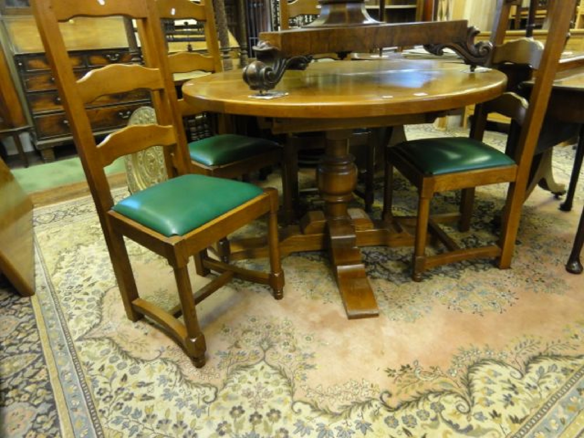 Appraisal: A substantial oak dining table circular when closed enclosing an