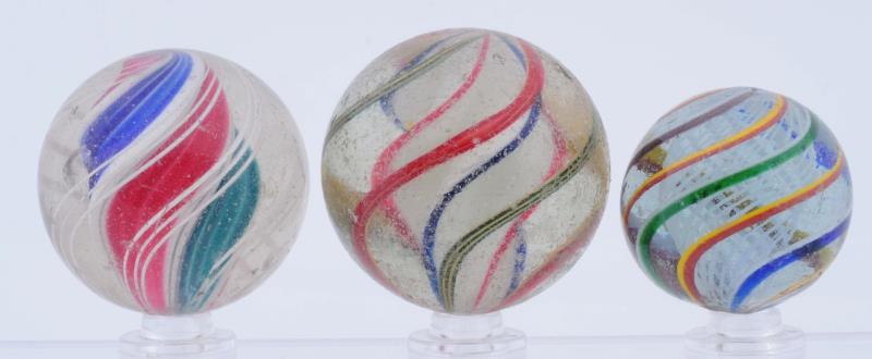 Appraisal: Lot Of Swirl Marbles Lot includes a multicolor white latticino