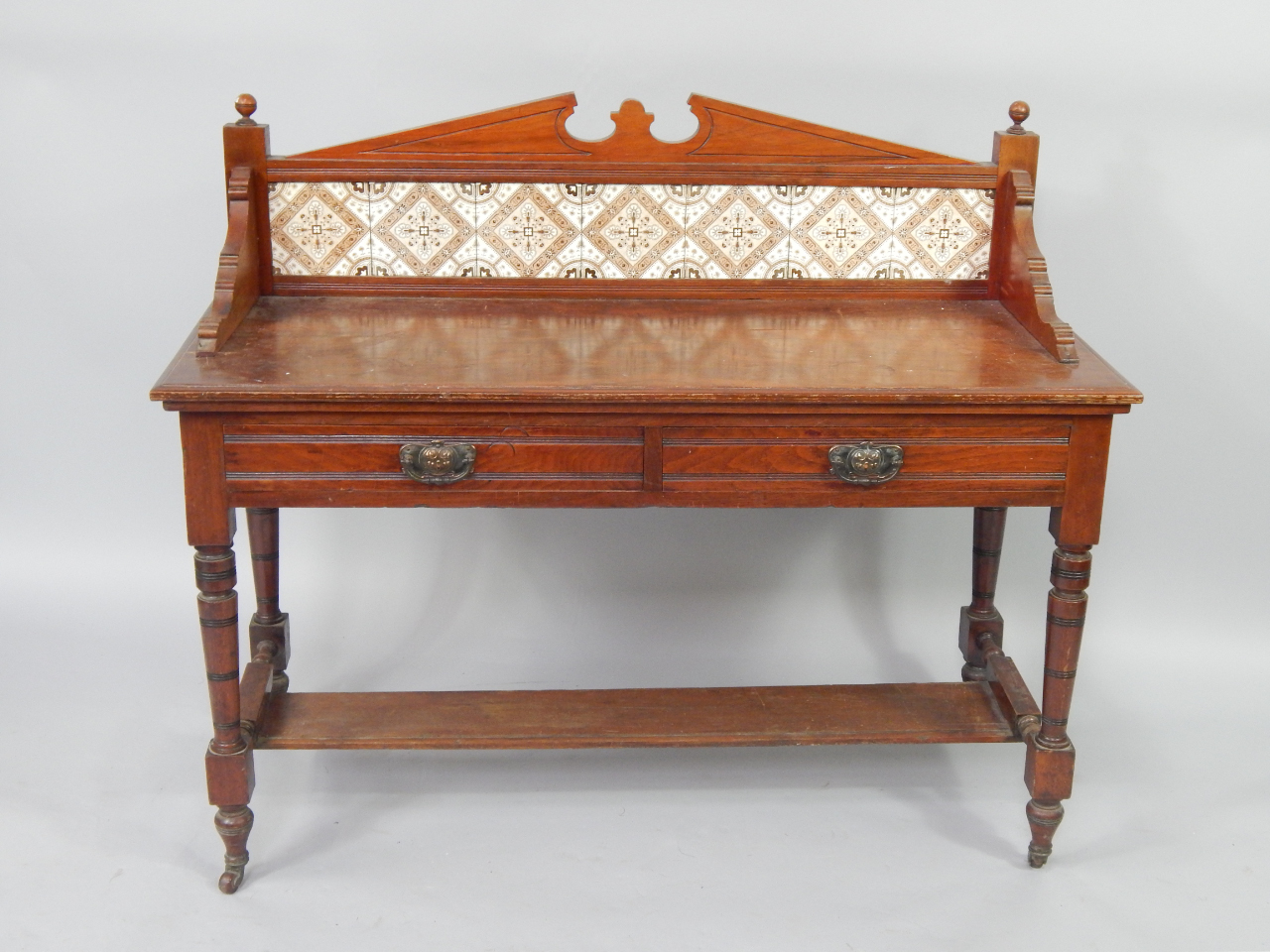 Appraisal: A Victorian walnut wash stand with brown tiled splash back