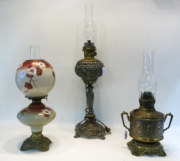 Appraisal: HREE VICTORIAN STYLE KEROSENE TABLE LAMPS in various motifs brass