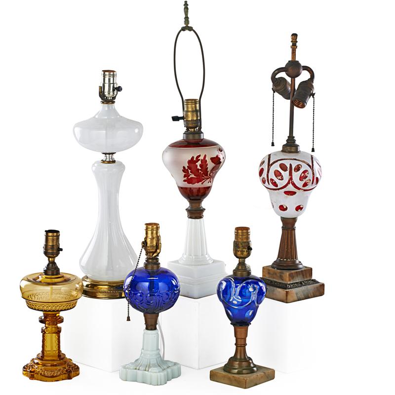 Appraisal: CONTINENTAL TABLE LAMPS Seven Five composite oil lamps one Vaseline