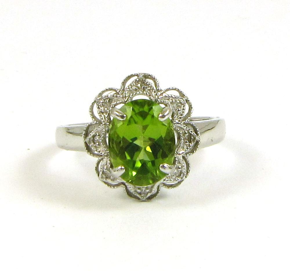 Appraisal: PERIDOT DIAMOND AND FOURTEEN KARAT GOLD RING The k white