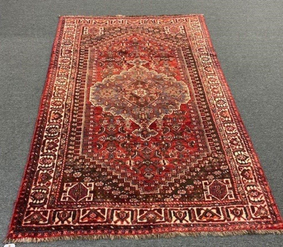 Appraisal: Shiraz center hall carpet red field center medallion handmade in