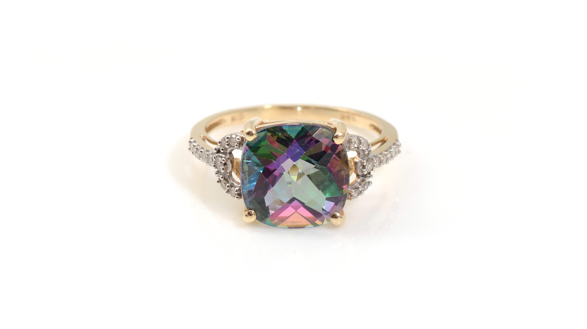 Appraisal: MYSTIC TOPAZ AND DIAMOND RING K yellow gold ring contains