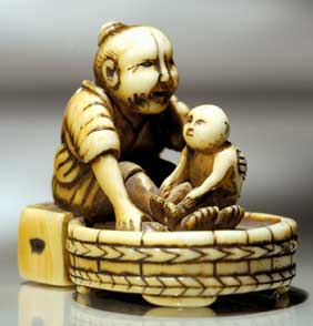 Appraisal: ANTIQUE IVORY NETSUKE Well carved and antique ivory netsuke of