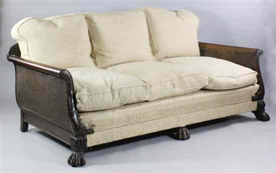 Appraisal: A 's carved walnut bergere settee with double caned back