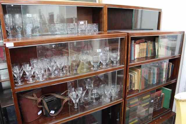 Appraisal: A GROUP OF FOUR MINTY BOOKCASES all with sliding glass