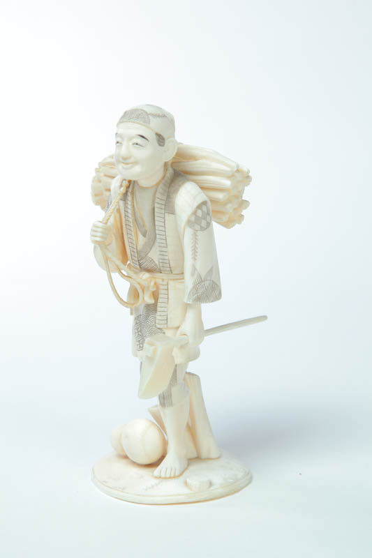 Appraisal: CARVED IVORY FIGURE Japan late th-early th century Woodcutter carrying