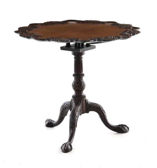 Appraisal: Georgian carved mahogany tilt-top table circa scalloped-edge piecrust top with