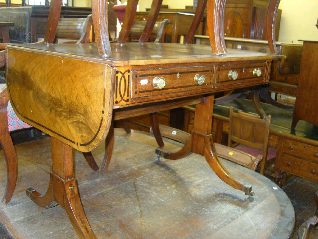 Appraisal: A Regency mahogany sofa table fitted with four flaps two