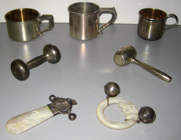 Appraisal: STERLING SILVER CHILD MUGS AND BABY RATTLES Three mugs with