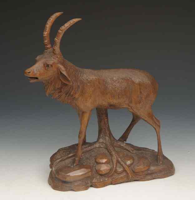 Appraisal: A CARVED BLACK FOREST MODEL OF AN IBEX standing on