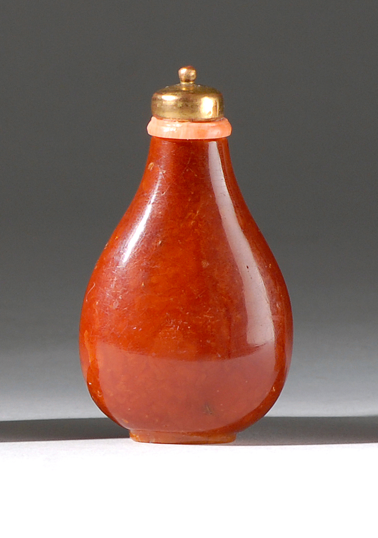 Appraisal: AMBER SNUFF BOTTLE Mid- th CenturyIn pear shape with burl-like