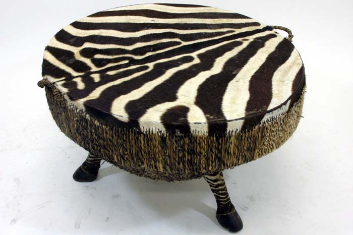 Appraisal: AFRICAN ZEBRA DRUM COCKTAIL TABLE The circular wood drum has