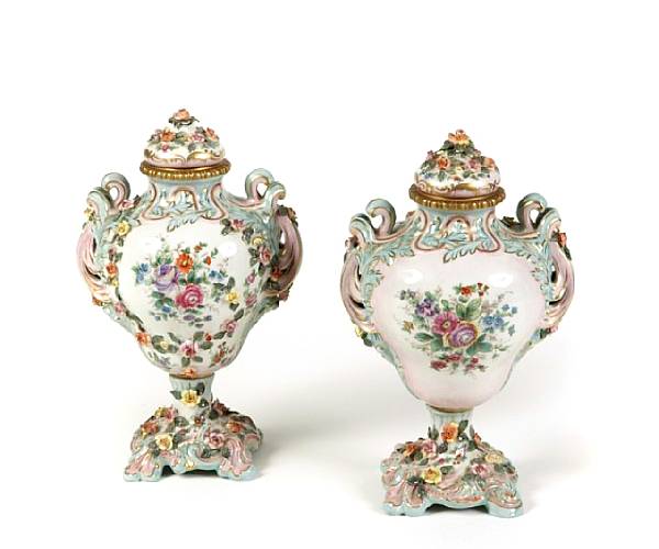 Appraisal: A pair of French paint decorated covered urns th century