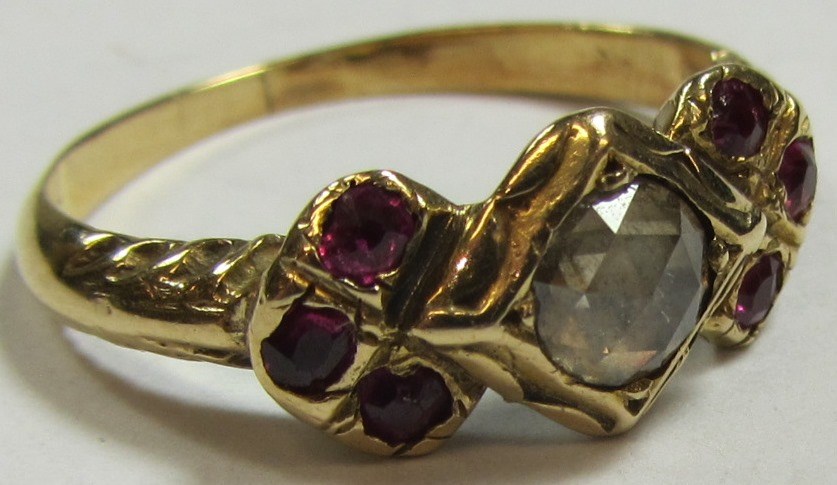 Appraisal: A gold ring mounted with a rose diamond at the