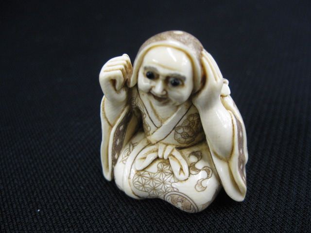 Appraisal: Carved Ivory Netsuke of a Kneeling Ghost onyx eyes signed