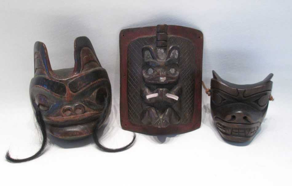 Appraisal: THREE NORTHWEST NATIVE AMERICAN WOOD CARVINGS including a seal maskette