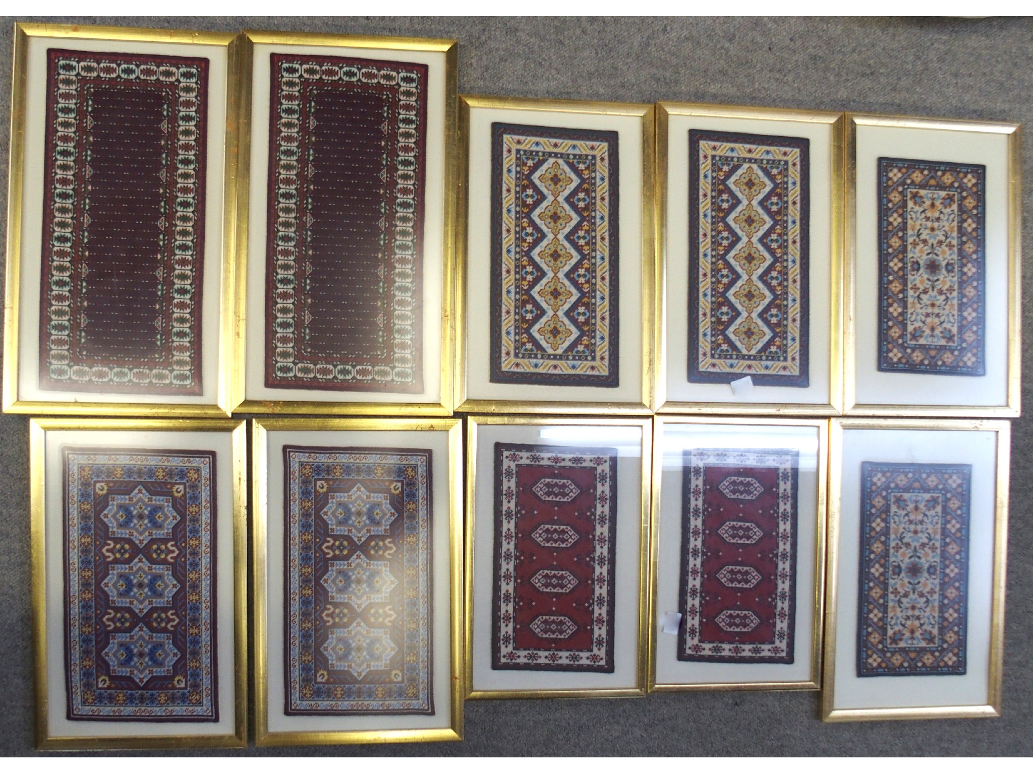 Appraisal: Box comprising various framed miniature Persian rugs