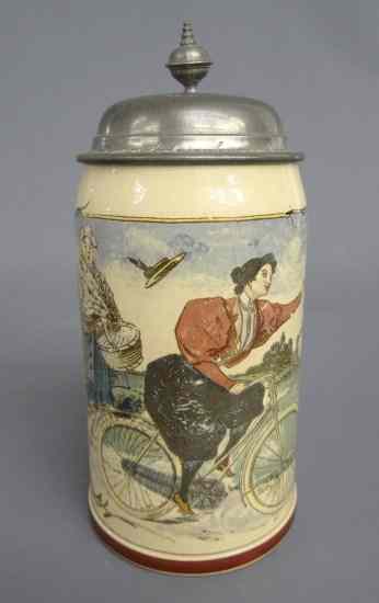 Appraisal: German stein painted with female cyclist Dated on base ''