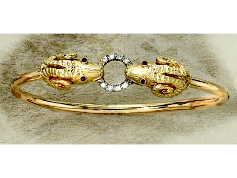 Appraisal: RAMS HEAD DIAMOND AND RUBY BANGLE k yellow gold bangle