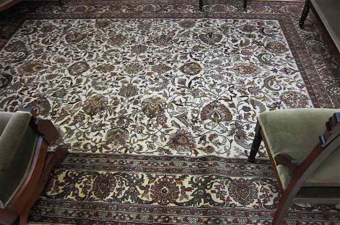 Appraisal: HAND KNOTTED ORIENTAL CARPET Indo-Persian overall floral pattern on cream