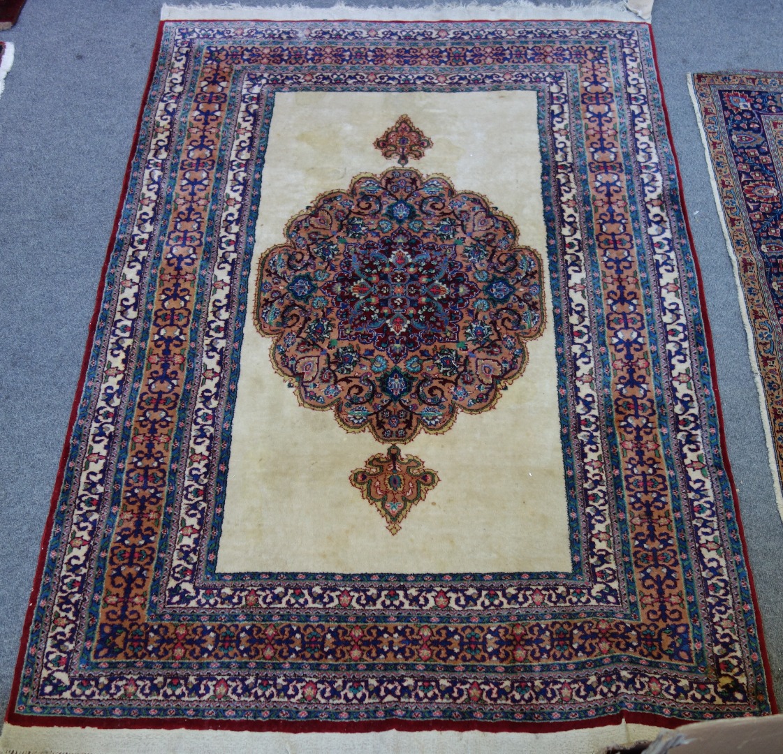 Appraisal: An Indian rug the plain ivory field with a bold