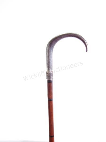 Appraisal: Gun And Dagger Combination Cane wood and metal shaft opens