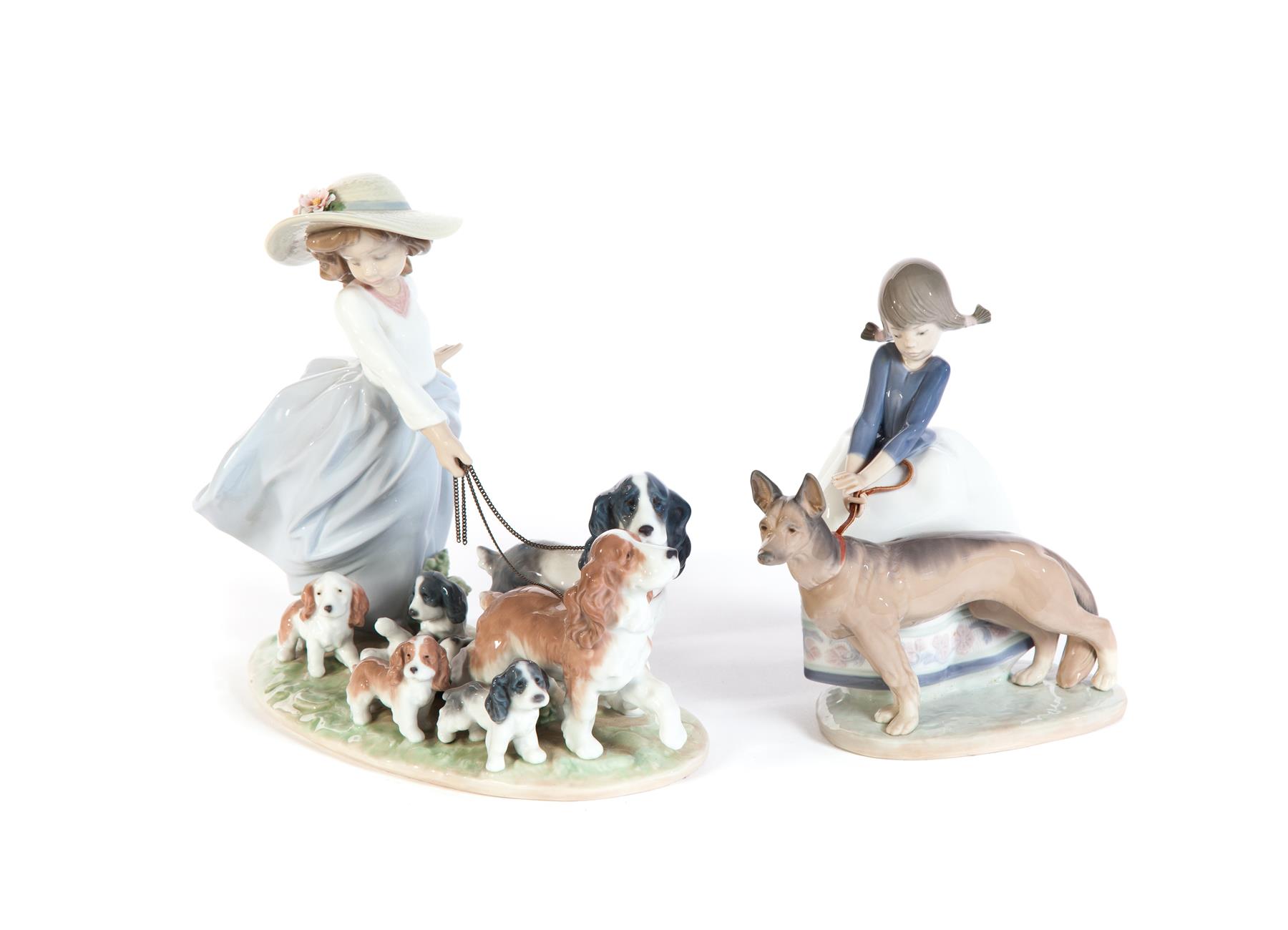 Appraisal: TWO LLADRO FIGURES OF DOG WALKERS Spain th century High