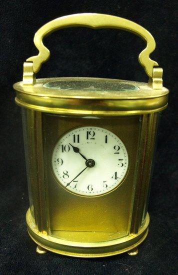 Appraisal: An oval gilt brass carriage clock with circular dial on