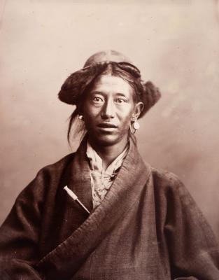 Appraisal: Portrait of a Tibetan Servant half-length wearing a coat with