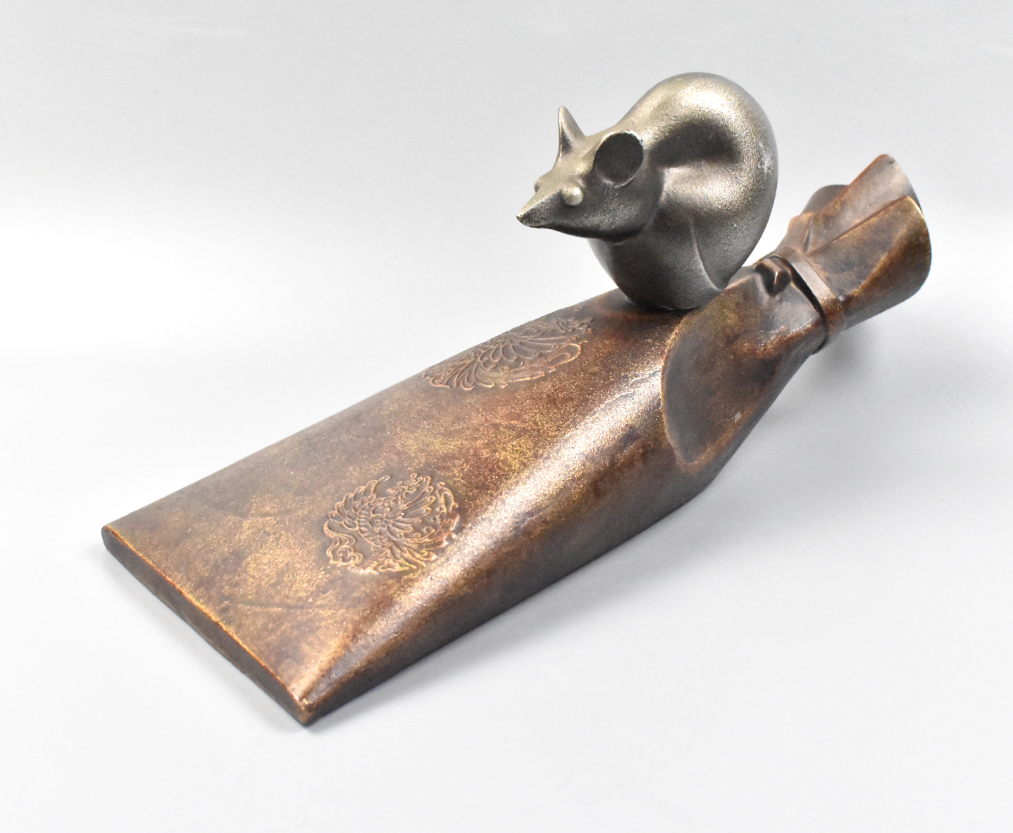 Appraisal: A Japanese bronze mouse perched on a sac Meiji Period