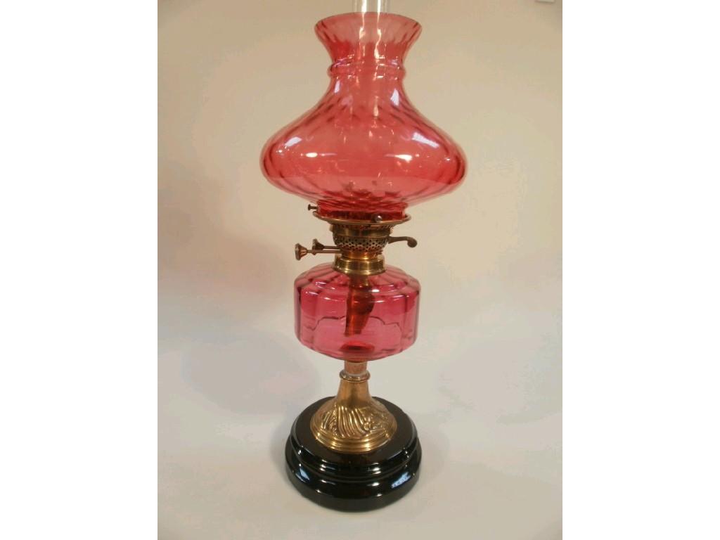 Appraisal: A Victorian brass and Cranberry glass oil lamp with brass