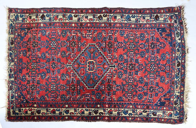 Appraisal: Hamadan red ground rugwith small central medallion and multiple border