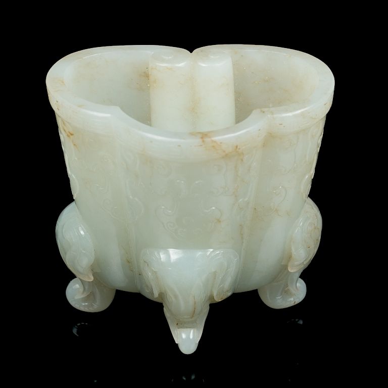 Appraisal: WHITE JADE RUYI-FORM CUP QING The cup of a ruyi